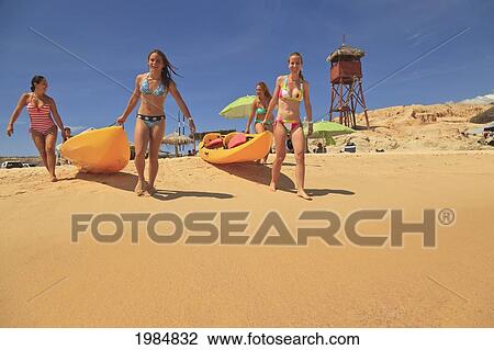 Young Women Pulling Boats Over The Sand; Baja California Sur Mexico View Large Photo Image Stock Image - Young Women Pulling Boats Over The Sand; Baja California Sur Mexico. Fotosearch