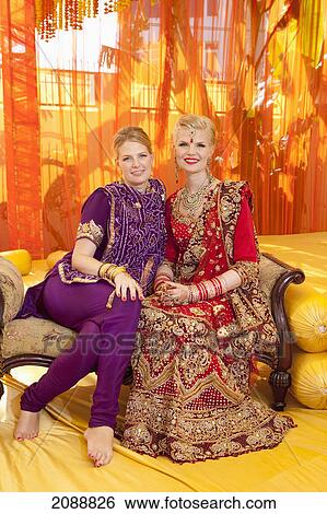 Stock Photograph - A bride and her attendant in traditional wedding attire; ludhiana, punjab, india. Fotosearch