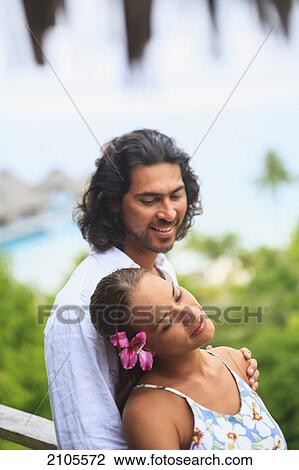Stock Image - A couple in love at bora bora nui resort and spa; bora bora island society islands french polynesia south pacific. Fotosearch