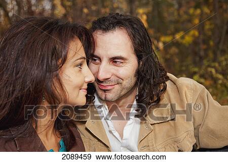 Stock Photo - A couple spending quality time together in a park in autumn; edmonton, alberta, canada. Fotosearch