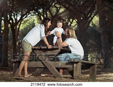 A family with a baby at a picnic table; tarifa cadiz andalusia spain View Large Photo Image Stock Image - A family with a baby at a picnic table; tarifa cadiz andalusia spain. Fotosearch
