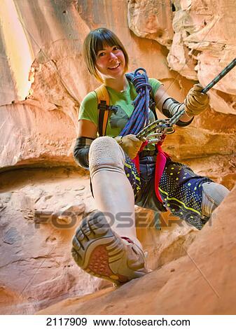 Stock Photo - A female athlete exploring utah slot canyons; hanksville utah united states of america. Fotosearch