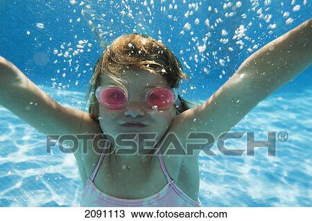 A girl swimming under the water in a pool with goggles on; tarifa, cadiz, andalusia, spain View Large Photo Image Stock Image - A girl swimming under the water in a pool with goggles on; tarifa, cadiz, andalusia, spain. Fotosearch