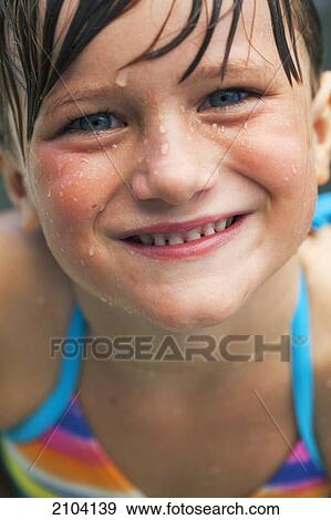 Stock Photo - A girl with water droplets on her face; gold coast queensland australia. Fotosearch