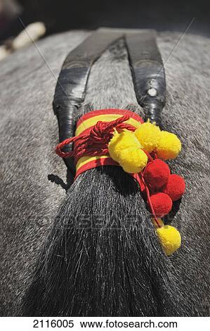 Stock Photography - A horse's tail decorated in spanish flag colours for the april fair; seville andalusia spain. Fotosearch
