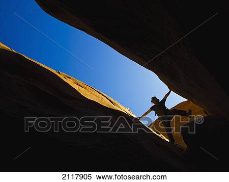 Stock Photography - A male athlete exploring utah slot canyons; hanksville utah united states of america. Fotosearch