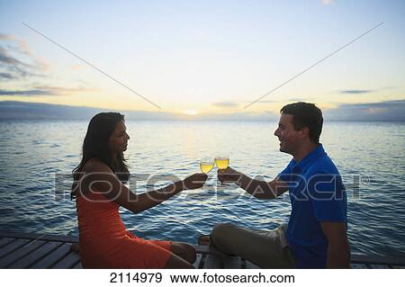 A man and woman give a toast with drinks at the bora bora nui resort and spa; bora bora island society islands french polynesia south pacific View Large Photo Image Stock Photo - A man and woman give a toast with drinks at the bora bora nui resort and spa; bora bora island society islands french polynesia south pacific. Fotosearch