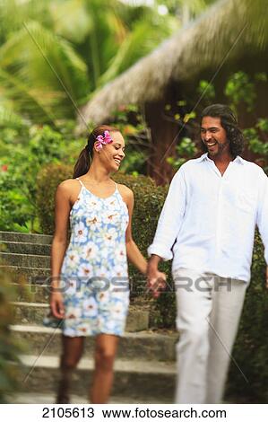 A man and woman hold hands and walk through the bora bora nui resort and spa; bora bora island society islands french polynesia south pacific View Large Photo Image Stock Image - A man and woman hold hands and walk through the bora bora nui resort and spa; bora bora island society islands french polynesia south pacific. Fotosearch