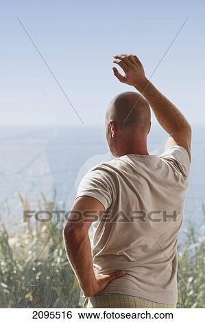 A man leaning on a window looking out to sea; tarifa cadiz andalusia spain View Large Photo Image Stock Photograph - A man leaning on a window looking out to sea; tarifa cadiz andalusia spain. Fotosearch