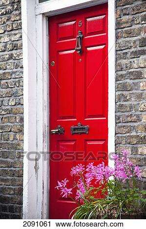 Stock Image - A painted red door on a house; dublin city, county dublin, ireland. Fotosearch