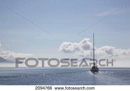 A sailboat cruises on a sunny day in the gulf islands; british columbia, canada View Large Photo Image Stock Photograph - A sailboat cruises on a sunny day in the gulf islands; british columbia, canada. Fotosearch