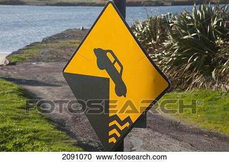 Stock Image - A sign on the road indicating an abrupt edge at derrynane harbour; county kerry, ireland. Fotosearch