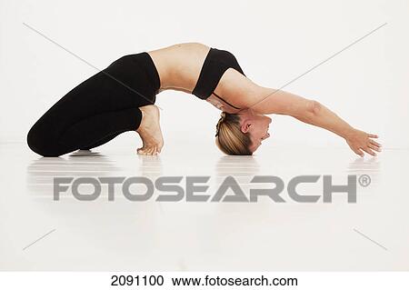 A woman in a yoga pose; tarifa, cadiz, andalusia, spain View Large Photo Image Stock Image - A woman in a yoga pose; tarifa, cadiz, andalusia, spain. Fotosearch