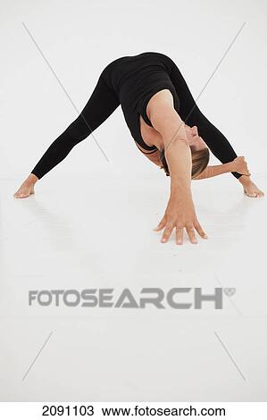 A woman in a yoga pose; tarifa, cadiz, andalusia, spain View Large Photo Image Stock Image - A woman in a yoga pose; tarifa, cadiz, andalusia, spain. Fotosearch