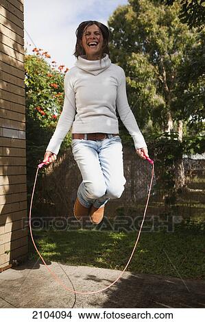 A woman jumping rope; gold coast queensland australia View Large Photo Image Picture - A woman jumping rope; gold coast queensland australia. Fotosearch