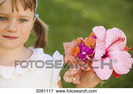 A young girl holding a colourful bouquet of flowers; torremolinos, malaga, spain View Large Photo Image Stock Photo - A young girl holding a colourful bouquet of flowers; torremolinos, malaga, spain. Fotosearch