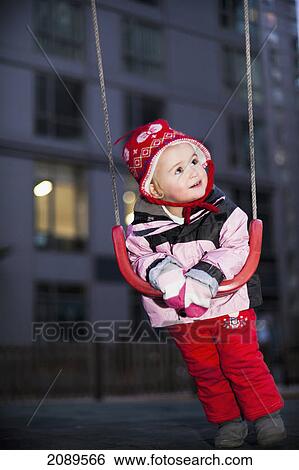 A young girl leaning on a swing at the playground; beijing, china View Large Photo Image Stock Photograph - A young girl leaning on a swing at the playground; beijing, china. Fotosearch