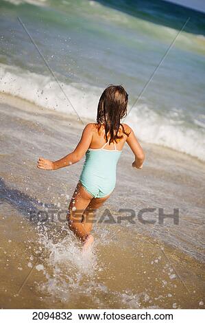A young girl runs in the ocean from the beach; gold coast queensland australia View Large Photo Image Stock Image - A young girl runs in the ocean from the beach; gold coast queensland australia. Fotosearch