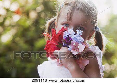 A young girl smelling a colourful bouquet of flowers; torremolinos, malaga, spain View Large Photo Image Stock Photograph - A young girl smelling a colourful bouquet of flowers; torremolinos, malaga, spain. Fotosearch
