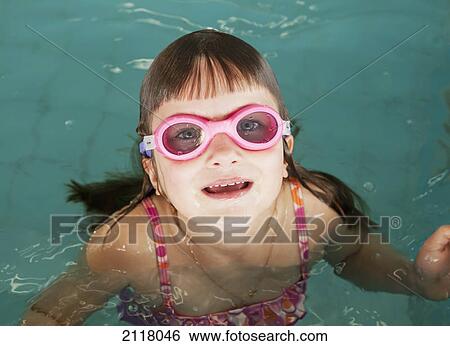A young girl wearing pink goggles in a swimming pool; gold coast queensland australia View Large Photo Image Stock Photograph - A young girl wearing pink goggles in a swimming pool; gold coast queensland australia. Fotosearch