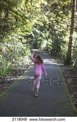 A young girl wearing pink walks down a trail in springbrook national park; currumbin gold coast queensland australia View Large Photo Image Stock Photo - A young girl wearing pink walks down a trail in springbrook national park; currumbin gold coast queensland australia. Fotosearch