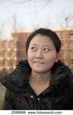 A young woman bites her lip and looks up and to the right; beijing, china View Large Photo Image Stock Photograph - A young woman bites her lip and looks up and to the right; beijing, china. Fotosearch