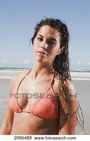 A young woman in a bikini poses on the beach; gold coast queensland australia View Large Photo Image Stock Photo - A young woman in a bikini poses on the beach; gold coast queensland australia. Fotosearch