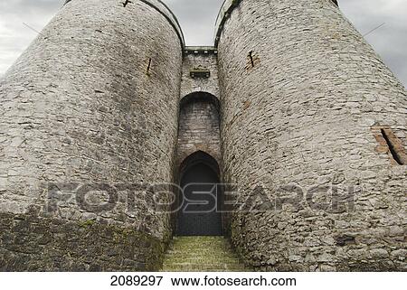 An arched doorway in between two round towers; ireland View Large Photo Image Stock Photo - An arched doorway in between two round towers; ireland. Fotosearch