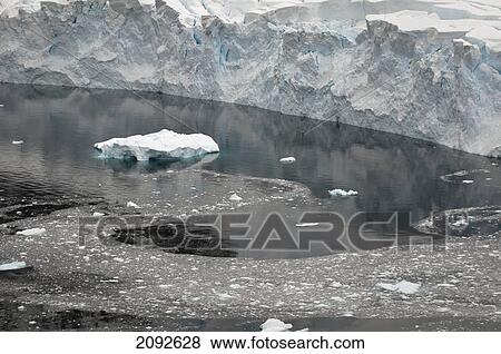An iceberg floating in the ocean along the coast; antarctica View Large Photo Image Stock Photo - An iceberg floating in the ocean along the coast; antarctica. Fotosearch