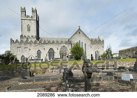 Stock Photograph - An old church building with a tower a cemetery; ireland. Fotosearch