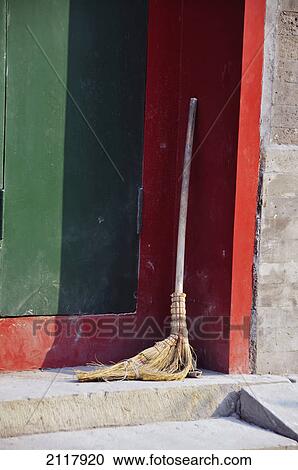 Stock Image - An old straw broom resting in the corner; beijing china. Fotosearch