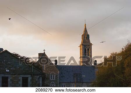 Stock Image - Bell tower of a church at sunset; ireland. Fotosearch