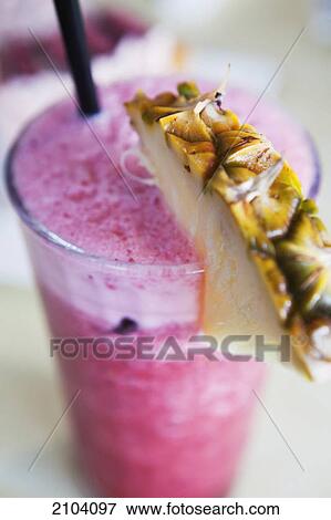 Stock Photo - Berry drink with pineapple garnish; gold coast queensland australia. Fotosearch