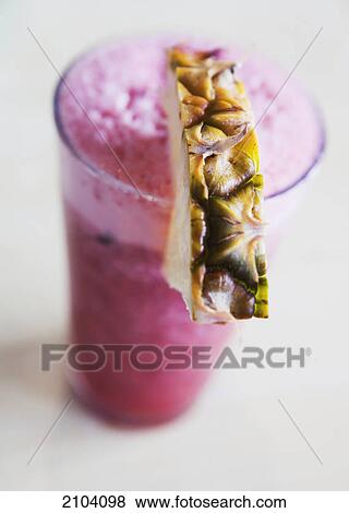 Stock Photo - Berry drink with pineapple garnish; gold coast queensland australia. Fotosearch