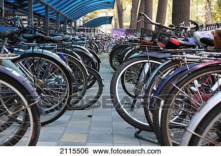 Bicycles parked in a row; beijing china View Large Photo Image Stock Photograph - Bicycles parked in a row; beijing china. Fotosearch