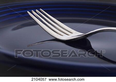 Close up of a fork on a blue plate; calgary alberta canada View Large Photo Image Stock Photo - Close up of a fork on a blue plate; calgary alberta canada. Fotosearch