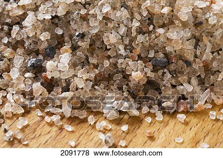 Stock Photo - Close up of rock salt on a wooden cutting board; calgary, alberta, canada. Fotosearch
