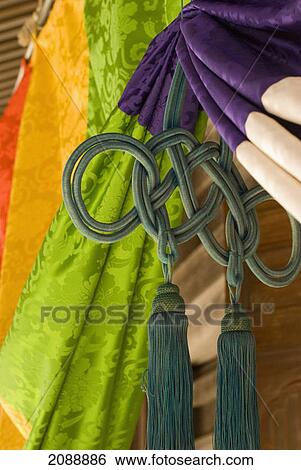 Stock Photograph - Colorful japanese fabric in front of a shrine; koyasan, wakayama, japan. Fotosearch