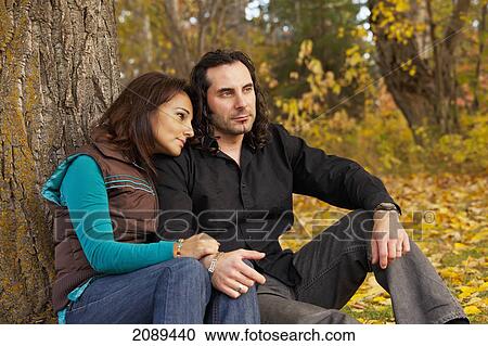 Couple spending quality time together in a park in autumn; edmonton, alberta, canada View Large Photo Image Stock Image - Couple spending quality time together in a park in autumn; edmonton, alberta, canada. Fotosearch