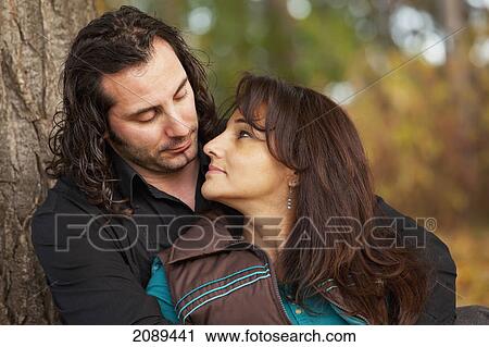 Couple spending quality time together in a park in autumn; edmonton, alberta, canada View Large Photo Image Stock Image - Couple spending quality time together in a park in autumn; edmonton, alberta, canada. Fotosearch