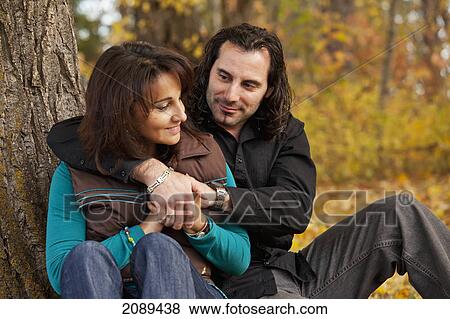 Stock Photo - Couple spending quality time together in a park in autumn; edmonton, alberta, canada. Fotosearch