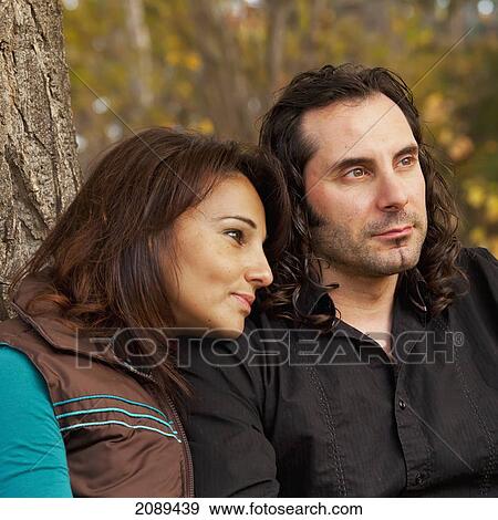 Couple spending quality time together in a park in autumn; edmonton, alberta, canada View Large Photo Image Stock Photo - Couple spending quality time together in a park in autumn; edmonton, alberta, canada. Fotosearch