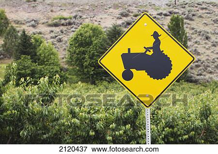 Farmer and tractor road sign with shrubs and gravel hillside in the background; summerland british columbia canada View Large Photo Image Stock Photo - Farmer and tractor road sign with shrubs and gravel hillside in the background; summerland british columbia canada. Fotosearch