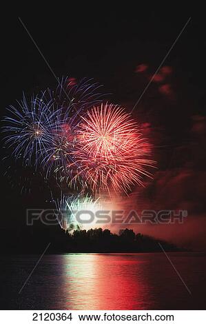 Picture - Fireworks displays reflecting off water; calgary alberta canada. Fotosearch