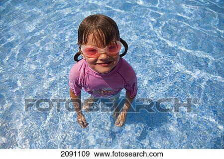 Girl at the swimming pool wearing goggles; tarifa, cadiz, andalusia, spain View Large Photo Image Stock Photo - Girl at the swimming pool wearing goggles; tarifa, cadiz, andalusia, spain. Fotosearch