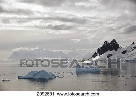 Icebergs and mountains along the coastline; antarctica View Large Photo Image Stock Image - Icebergs and mountains along the coastline; antarctica. Fotosearch