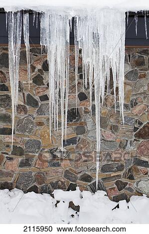 Icicles against a stone wall; wyoming united states of america View Large Photo Image Stock Image - Icicles against a stone wall; wyoming united states of america. Fotosearch