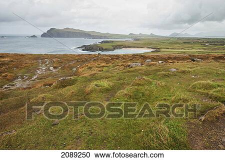 Landscape along the coast with cloudy sky; ireland View Large Photo Image Stock Image - Landscape along the coast with cloudy sky; ireland. Fotosearch