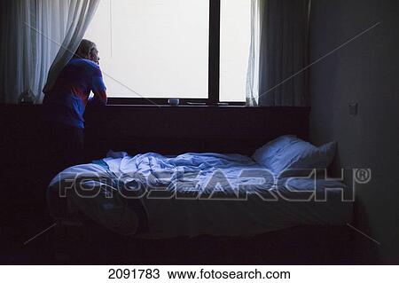 Man looking out of a bedroom window; perth, west australia, australia View Large Photo Image Stock Image - Man looking out of a bedroom window; perth, west australia, australia. Fotosearch