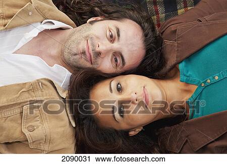Married couple laying on a blanket in a park; edmonton, alberta, canada View Large Photo Image Stock Image - Married couple laying on a blanket in a park; edmonton, alberta, canada. Fotosearch